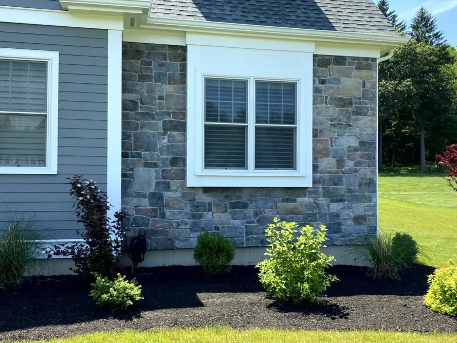 Natural stone veneer facade on a Massachusetts home by JS Masonry